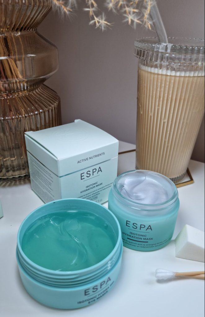 ESPA Isotonic Hydration Mask and Hydra Gel Eye Mask displayed next to vase and iced coffee.